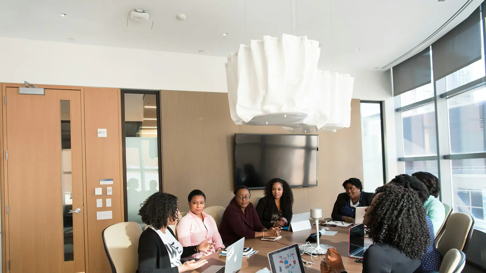 AI automation agency vs in-house — photography of people inside room during daytime