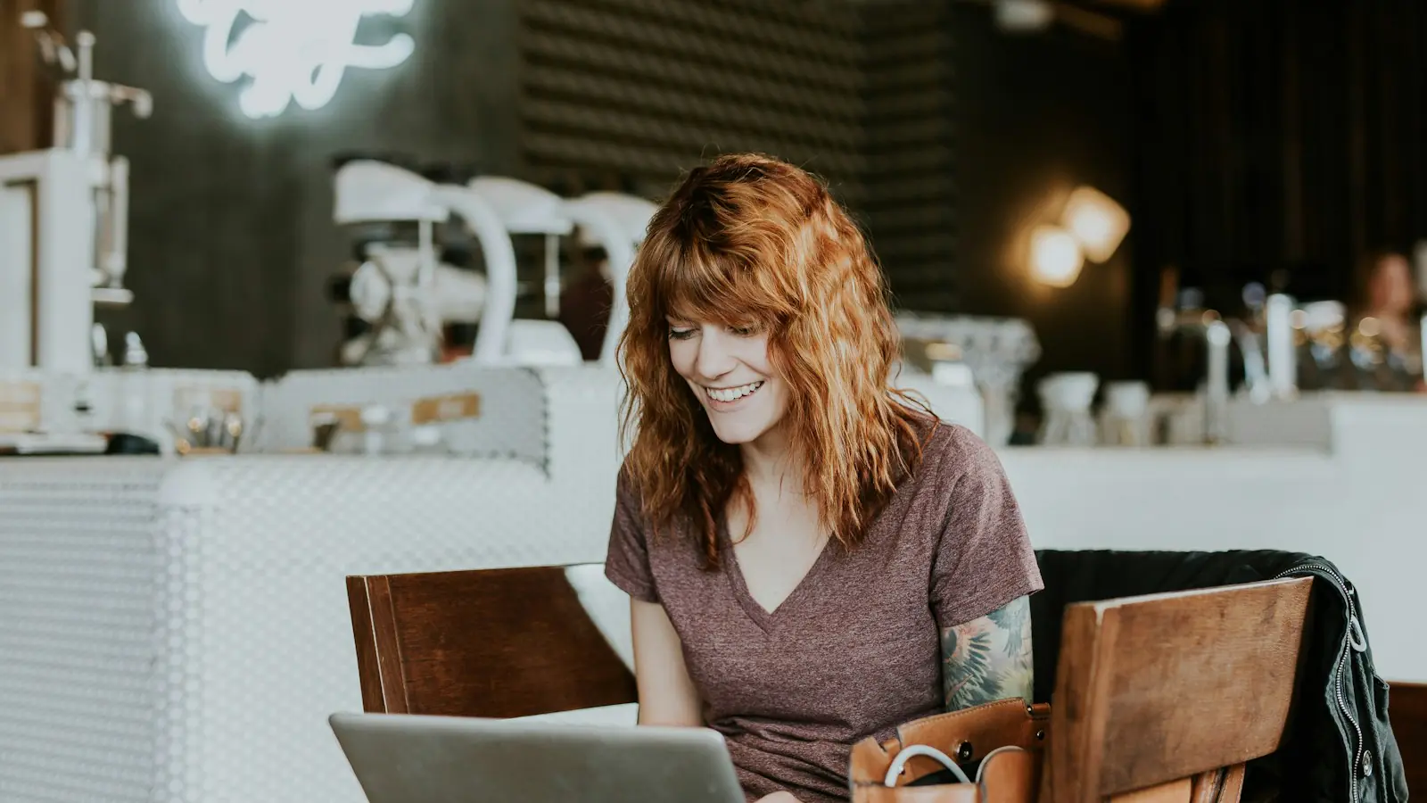 AI automation small business — woman sitting on brown wooden chair while using silver laptop computer in room