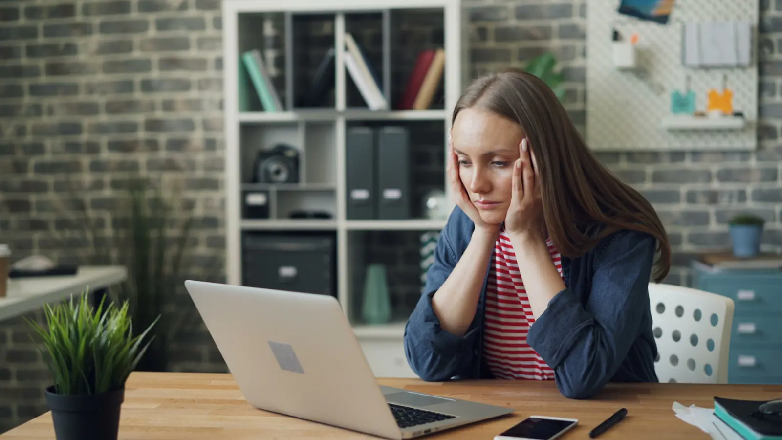 website not generating leads — a woman sitting at a table with a laptop in front of her